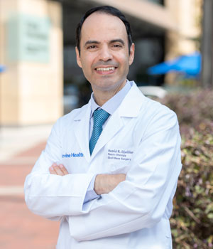 uci health otolaryngologist dr hamid djalilian standing outside uci health orange, formerly known as uci medical center, wearing a white coat