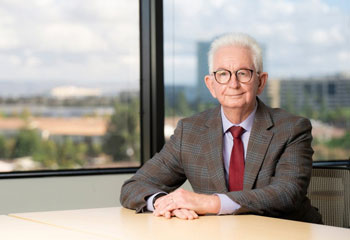 uci health psychiatrist and uc irvine school of medicine distinguished professor dr cameron s carter sitting at a conference table in front of windows on a cloudy day