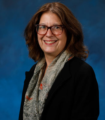 uci health neurologist and parkinsons disease researcher claire henchcliffe in front of a blue studio background