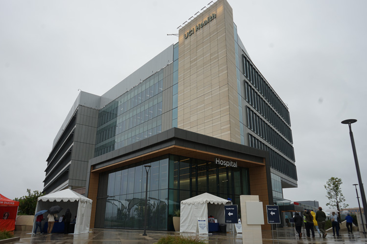 exterior of uci health irvine acute care hospital on cloudy rainy day