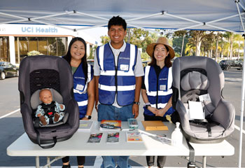 uci health family health center anaheim car seat program safety team members pose with car seats