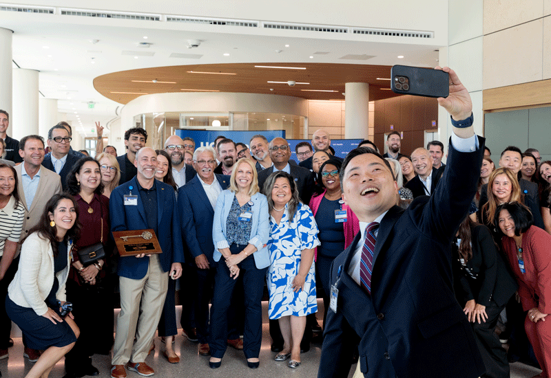 uci health chief operating officer and senior vice president nathan shinagawa takes large group selfie during an event to celebrate the new uci health irvine acute care hospital