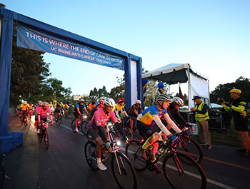 Cyclists kick off the UC Irvine Anti-Cancer Challenge just after dawn on Oct. 11, 2025. to support cancer research.