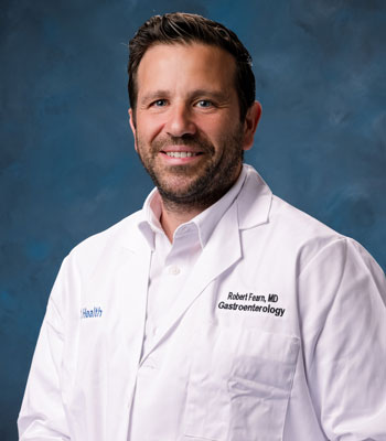 uci health gastroenterologist dr. robert fearn wearing a white coat in front of a blue studio background