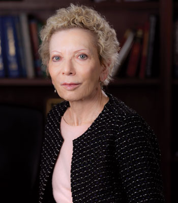 Distinguished Professor of pediatrics, anatomy & neurobiology, and neurology at UC Irvine’s School of Medicine Tallie Baram poses for a photo in a library