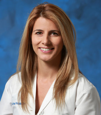 uci health cardiologist dr. ailin barseghian in a white coat in front of a blue studio background