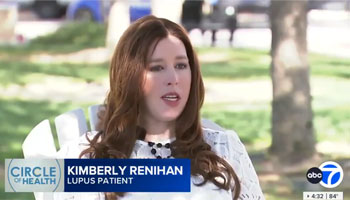 uci health patient kimberly renahan shares her experience with lupus on abc 7 sitting in a white chair on the lawn in front of uci medical center