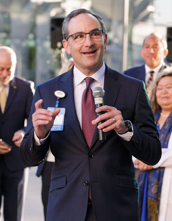 uci health chief medical officer and senior vice president dr. joseph carmichael speaking outside on the opening day of uci health — irvine in december 2025