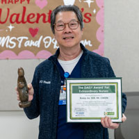 uci health nurse ronny ao holding his DAISY award certificate