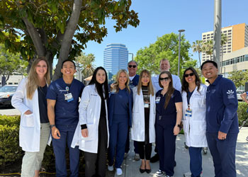 uci health nurses and physicians in white coats and scrubs gather at uci health orange to celebrate donate life month and encourage organ donation
