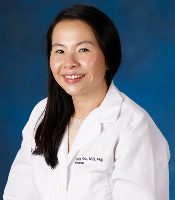 uci health dermatologist dr jessica shiu wearing a white coat in front of a blue studio background