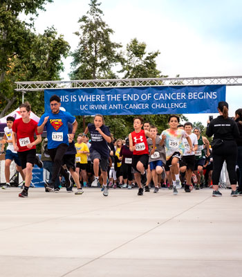 runners dash off at the start line for the annual uci anti-cancer challenge in irvine