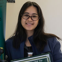 uci health nurse hannah andres holds her daisy award for nursing excellence