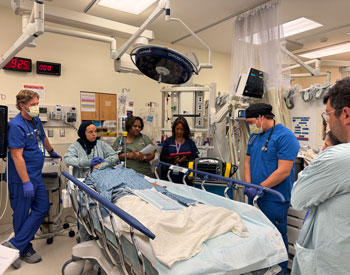 uci health clinicians discuss how to treat a pediatric trauma patient in a trauma bay during a drowning simulation 