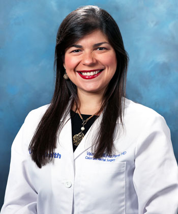uci health dr valery vilchez parra wearing a white coat in front of a blue background