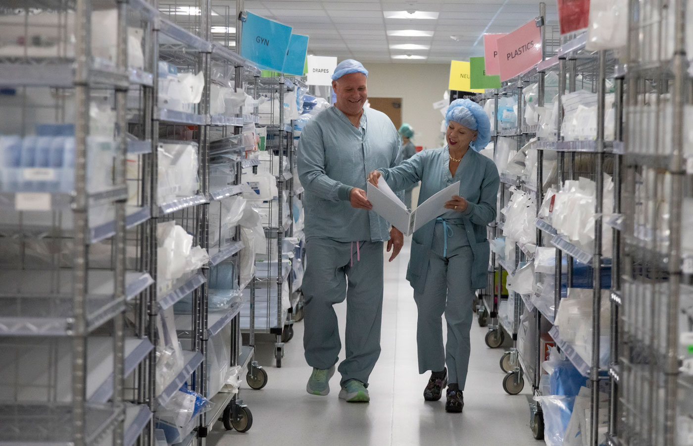 mara rosalsky vice president of perioperative services walks through the surgical supply area of the megafloor with another nurse
