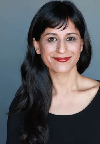 headshot of dr sunita puri a uci health internist who specializes in hospice and palliative medicine in front of a blue background