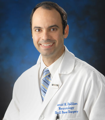 uci health otolaryngologist dr hamid djalilian wearing a white coat in front of a blue background