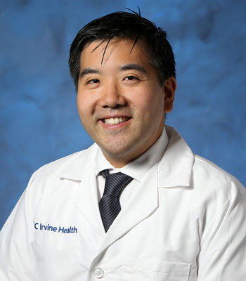 uci health autism and neurodevelopmental specialist dr peter chung wearing a white coat in front of a blue background