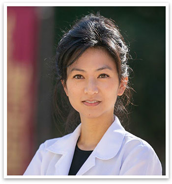 Dr. Frances E. Chow, pictured in a white coat, will lead the UCI Health Comprehensive Brain Tumor Program. 