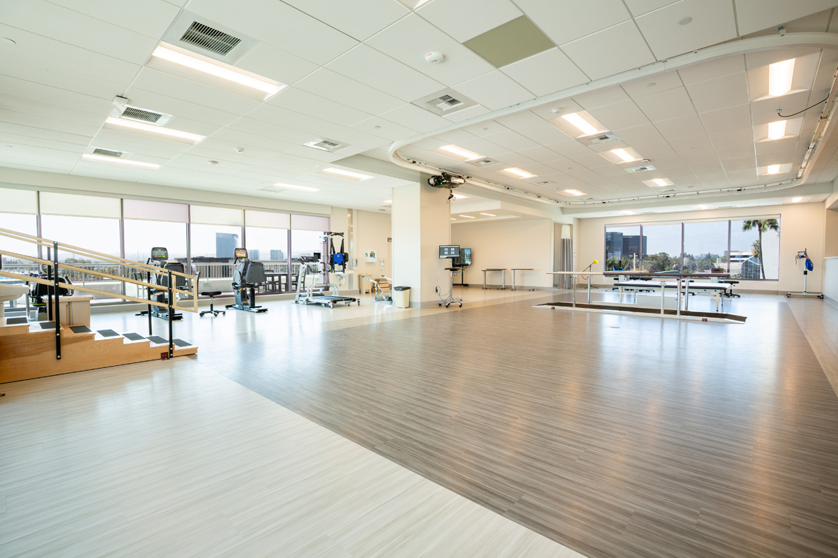 uci health — irvine rehabilitation hospital rehabilitation gym with large windows and equipment