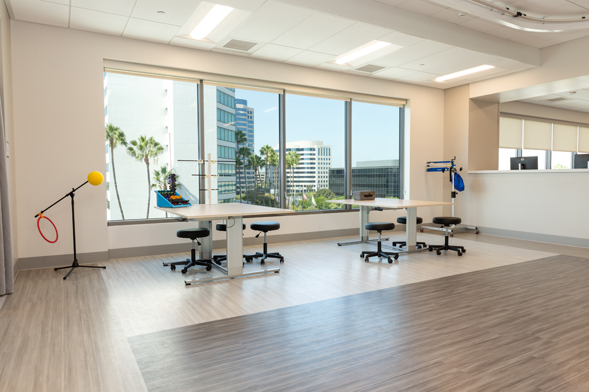 uci health — irvine rehabilitation hospital rehabilitation gym with large windows and equipment
