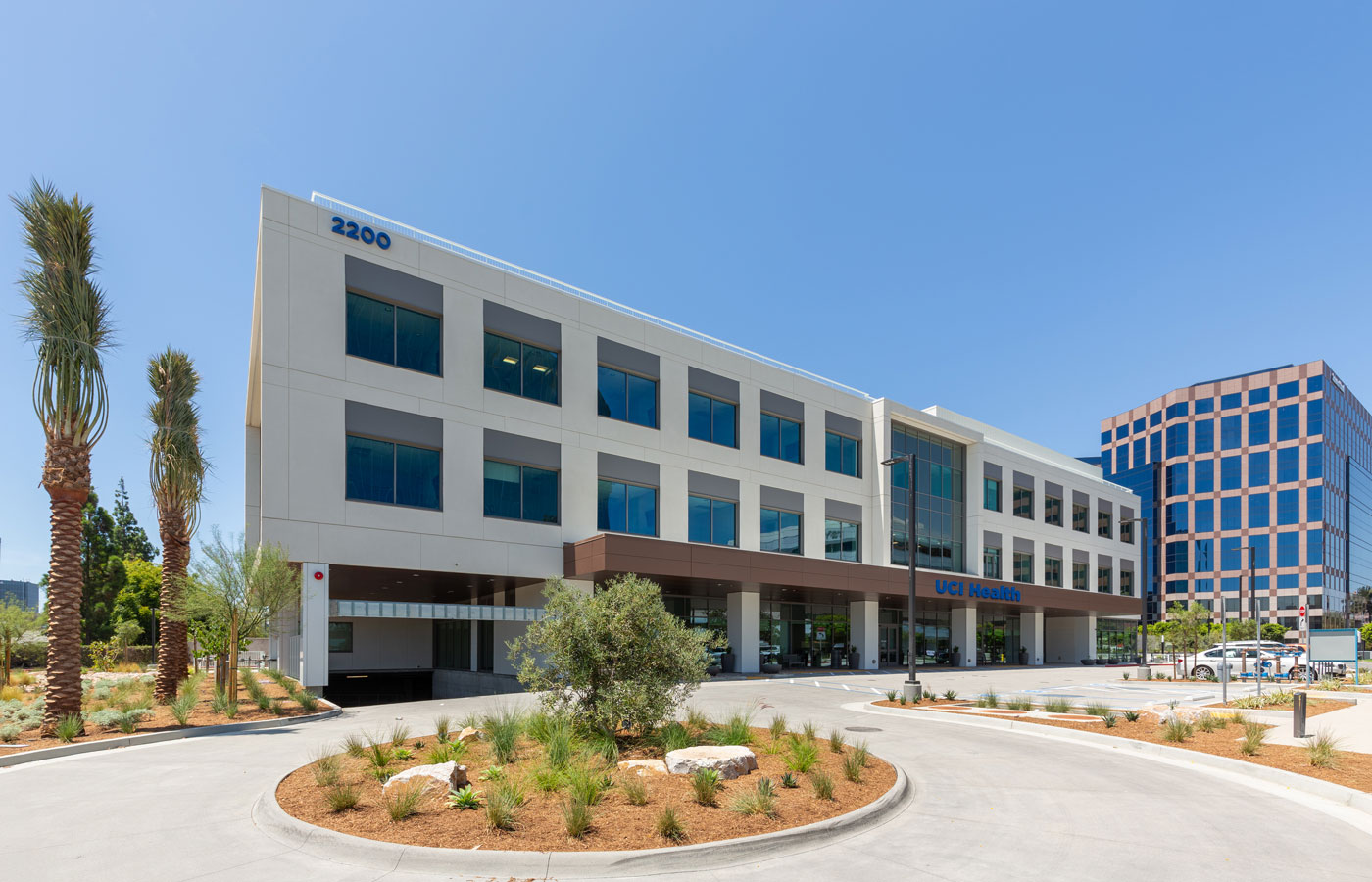 the exterior of the uci health — irvine rehabilitation hospital with buildings in the background