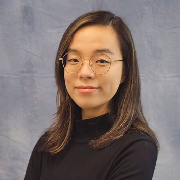 wenjun fan an assistant public health professor at uc irvine wearing black and standing in front of a gray studio background