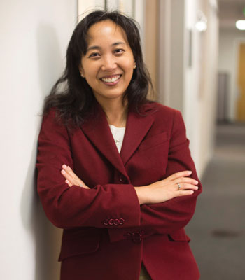 uci health epidemiology and infection prevention medical director dr. susan huang stands in a hallway with her arms crossed