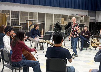UCI Health geriatrician Dr. Lisa Gibbs, Tim Steiner from the Royal Philharmonic Orchestra and Geoffrey Pope, DMA, director of orchestral studies at UC Irivine Claire Trevor School of the Arts“ train with UC Irvine music students.