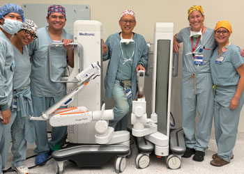uci health surgical team takes a selfie in scrubs and masks after the successful use of the first hugo robotic-assisted surgery system on the west coast