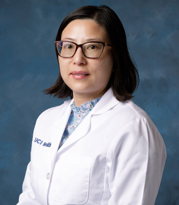 uci health nephrologist dr. yongen chang wearing a white coat in front of a blue studio background