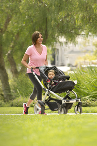 Elizabeth Hill pushes daughter Audrey through a neighborhood park on a sunny fall day.