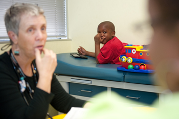 Nurse practitioner Teri Book meets with six-year-old autism patient Akintunde Udo and his mother.