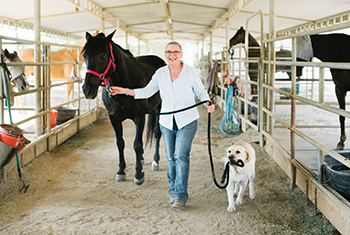 UCI Health ovarian cancer patient Meg Newton with her horses