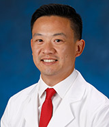 Dr. Hansen C. Bow, pictured in his lab coat, is a UCI Health neurosurgeon who specializes in minimally invasive spine surgery, cancer of the spine and degenerative back and neck disorders.