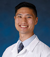 Dr. Stephen Chang, picture in his lab coat, is a board-certified UCI Health family medicine physician who specializes in primary care medicine.