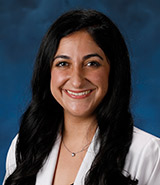 Dr. Roxana Ghashghaei, pictured in her lab coat, is a UCI Health cardiologist who specializes in the diagnosis and treatment of heart disease.