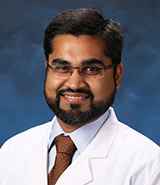 Dr. Ali Habib, pictured in his white coat, is a board-certified UCI Health neurologist who specializes in neuromuscular disorders including muscular dystrophy, Lou Gehrig's disease, myopathies and myasthenia gravis.