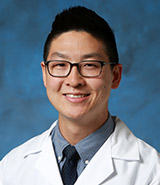 Dr. Brian Y. Kim, pictured in his white lab coat, is a board-certified UCI Health specialist in family and sports medicine who provides multidisciplinary care for active individuals, with a particular focus on runners and female athletes.
