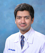 Dr. Kapil Mishra, a board-certified UCI Health ophthalmologist, wearing a whitecoat.