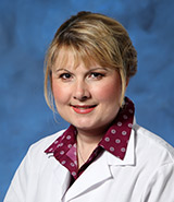 Dr. Andreea A. Nanci, in white lab coat, is a hematologist and oncologist who specializes in the medical treatment of patients with cancer and blood disorders.