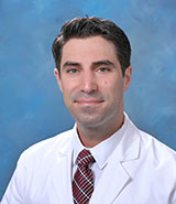 Dr. Sepehr Oliaei, a board-certified UCI Health otolaryngologist who specializes in the comprehensive management of ear, nose and throat disorders and surgical care of salivary gland and thyroid disease, wearing a whitecoat.