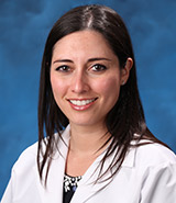 Dr. Betzy Salcedo, picture in her lab coat, is a board-certified UCI Health family medicine physician.