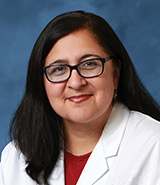 Dr. Bobby Sasson, pictured in her lab coat, is a board-certified UCI Health internal medicine physician who provides primary care services to patients. 