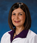 Dr. Mona Sazgar, pictured in her lab coat, is a board certified UCI Health neurologist who specializes in the diagnosis and treatment of epilepsy.