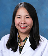 Dr. Jessica Shiu, picture in a lab coat, is a board-certified UCI Health dermatologist who specializes in vitiligo, inflammatory skin disorders, skin cancers and melanocytic neoplasms.