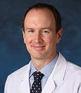 Dr. Matthew W. Wade, pictured in his lab coat, is a board-certified UCI Health eye surgeon who specializes in complex cataract surgery, cornea disease and transplantation, as well as LASIK vision correction.