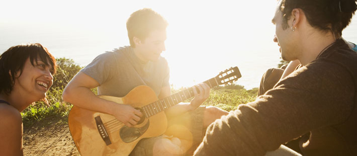 teens singing and playing guitar