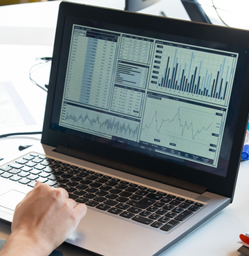 Data charts depicted on a laptop